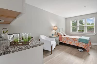Cozy resident room with floral bedding and natural light