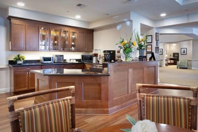 Bright, inviting common area with kitchenette and seating