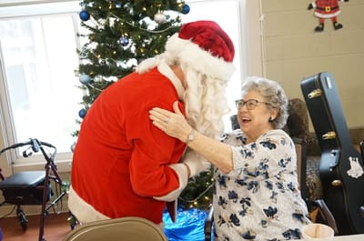 Santa interacting joyfully with a resident
