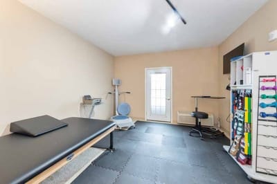Therapy room with equipment and exercise mats