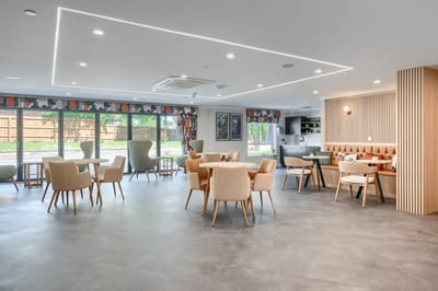 Bright common area with dining tables and chairs