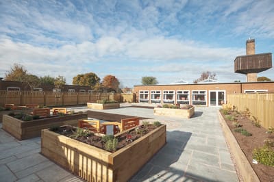 Outdoor garden area with raised beds and seating