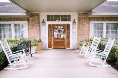 Entrance of The Reserve at Pasadena with rocking chairs