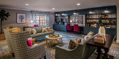 Cozy common area with colorful seating and bookshelves