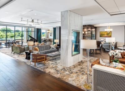 Sunny common area with comfortable seating and piano