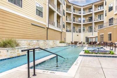 Outdoor pool area with seating and landscaping
