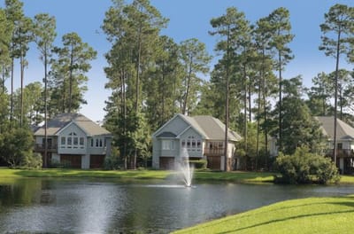 A view of buildings beside a serene lake