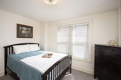 Private resident room with bed and dresser