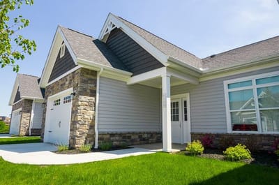 Exterior view of a senior living facility with landscaped yard