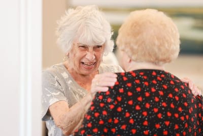 Two smiling senior women enjoying a conversation