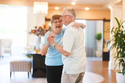 Residents dancing happily in a common area