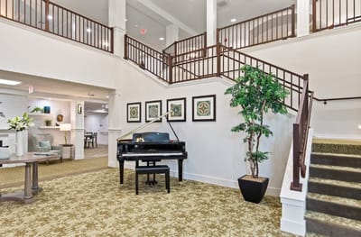 Interior view of a common area with a piano and decor