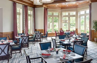 Bright dining room with tables set for meals
