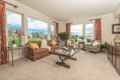 Bright and cozy common area with seating and large windows