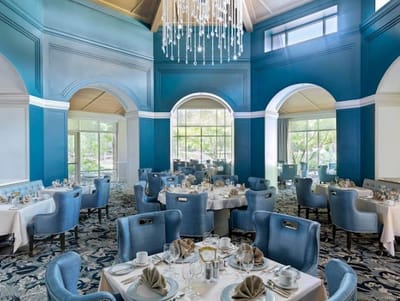 Elegant dining room setup with blue decor and chandelier