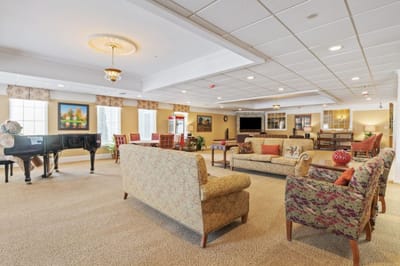 Bright common area with seating and a piano