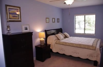 Interior view of a private resident room with bed
