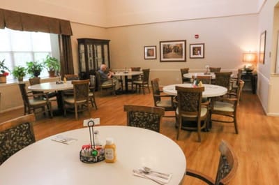 Dining room with tables and resident present