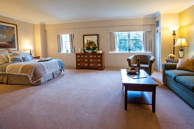 Bright and spacious resident room with a bed and seating area