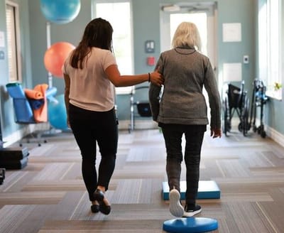 Staff assisting a resident during an activity session