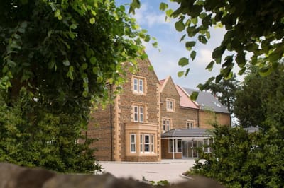 Exterior view of Wardington Court surrounded by greenery