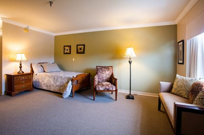 Cozy resident room with a bed and seating area
