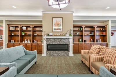 Common area with comfortable seating and bookshelf