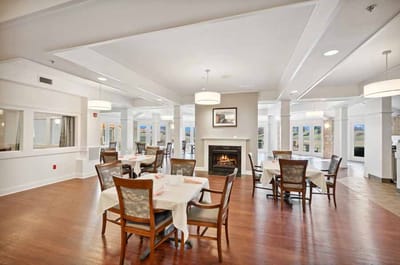 Dining area with tables and chairs near a fireplace
