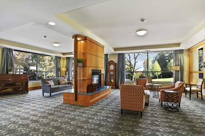 Bright common area with seating and large windows