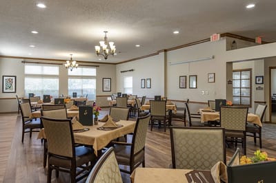 Dining area with tables and chairs arranged for residents