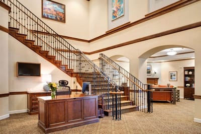 Bright lobby with a staircase and reception area