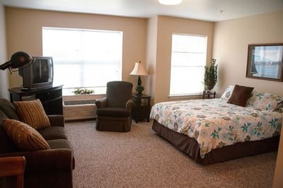 Comfortable resident room with bed and seating area