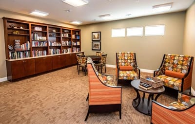 Cozy common area with comfortable seating and bookshelves
