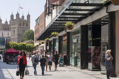 Busy street scene with shops and people.