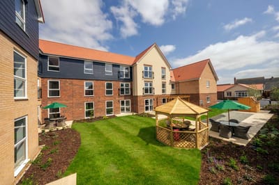 Exterior view of a retirement facility with garden