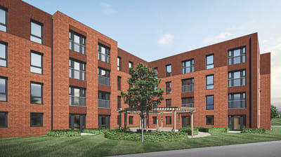 Exterior view of a brick building with landscaping.