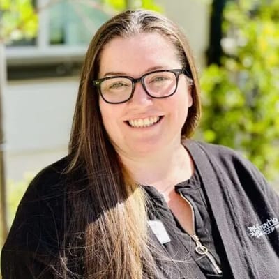 Staff member smiling in the outdoor area