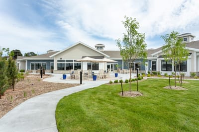 Exterior view of facility with outdoor seating and landscaping