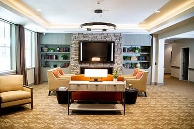 Bright common area with comfortable seating and a TV