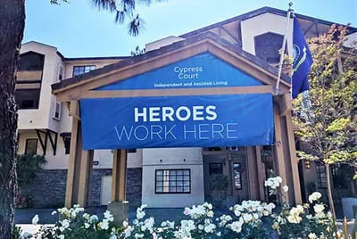 Entrance of Cypress Court with a promotional banner.