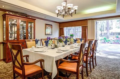 Dining room with a neatly set table and natural light