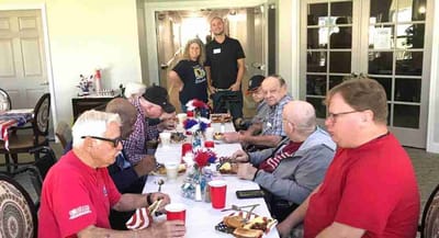 Residents enjoying a meal together at a dining table