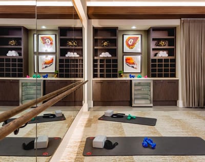 Interior view of a fitness area with exercise mats and weights