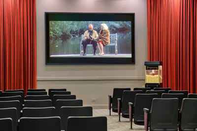 Interior view of a movie screening room with empty chairs