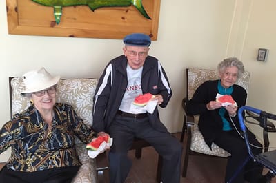 Residents enjoying watermelon in a common area