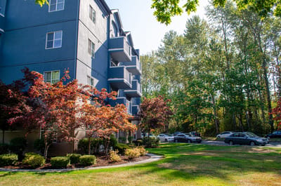Exterior view of a senior living facility with landscaped garden