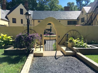 Pathway leading to a garden area with building in background