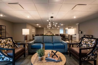 Common area with seating and lamps in a senior living facility