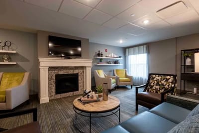 Common area with seating and fireplace in the facility