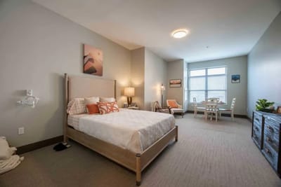 Private resident room with a bed and dining table